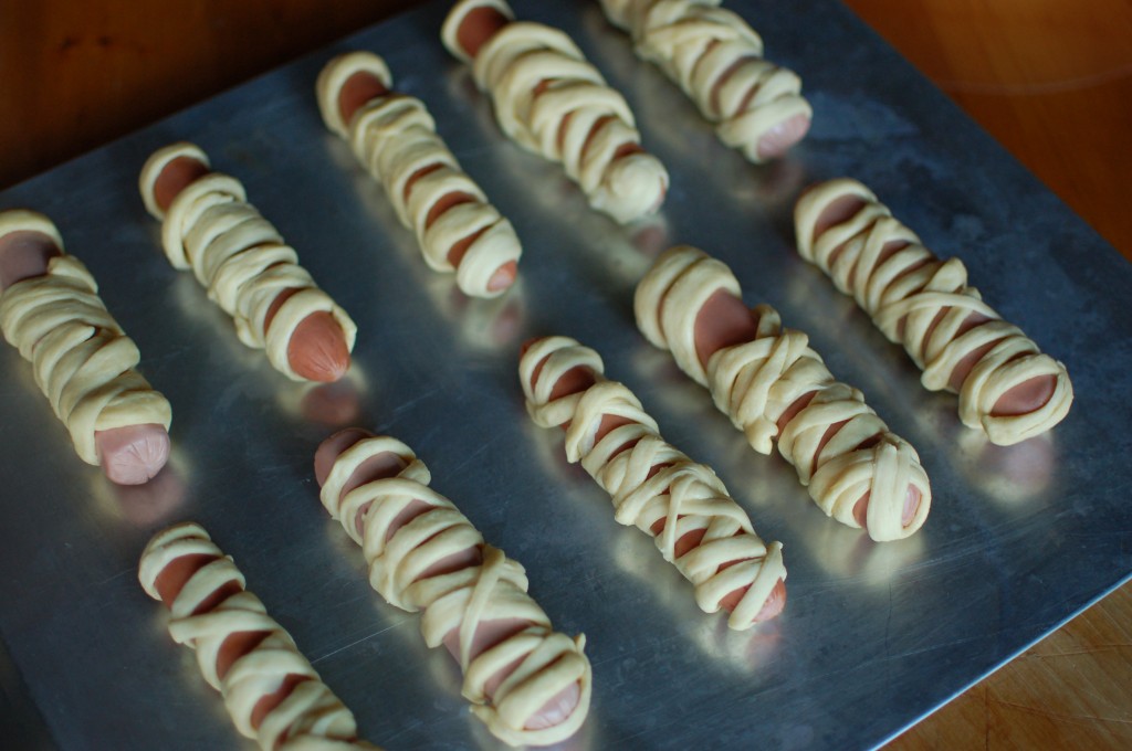 Hot dog mummies on the baking sheet